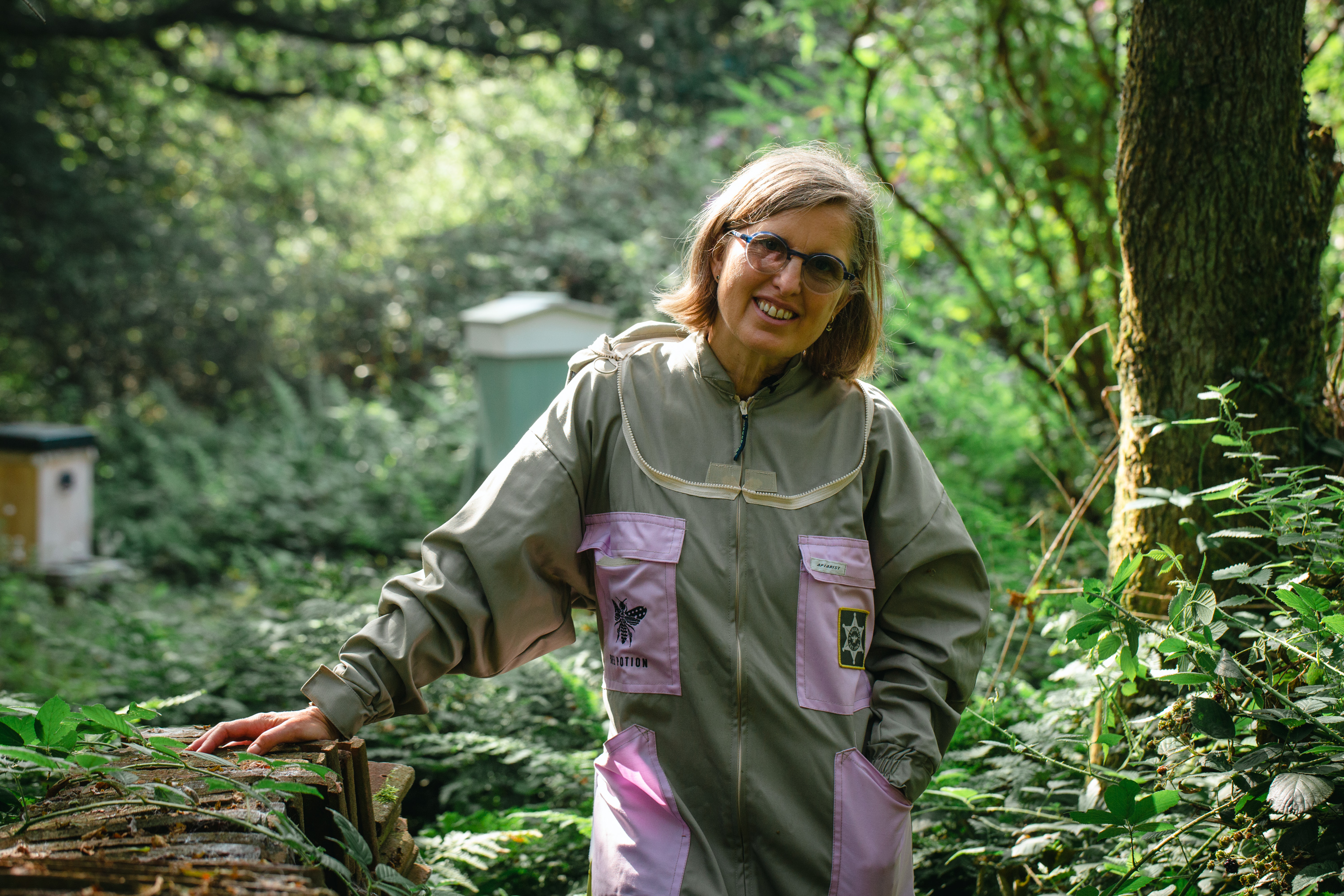 Woman in beekeeping clothing in wood